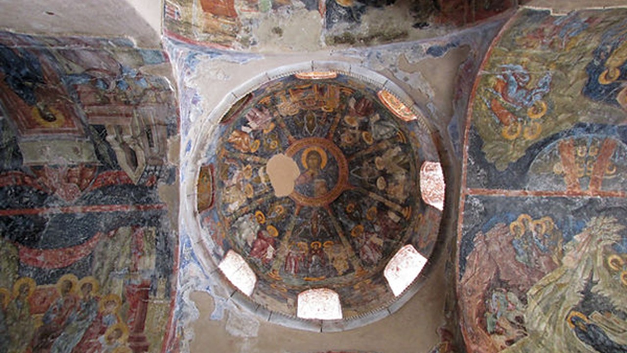 Interior view of the frescoed roof (dome) of the Katholikon at Perivléptos Monastery, showing the large central image of Christ Pantokrator (Christ as ruler of all) within the dome, painted in vivid colors on the curved vaults of this 14th-century church interior.