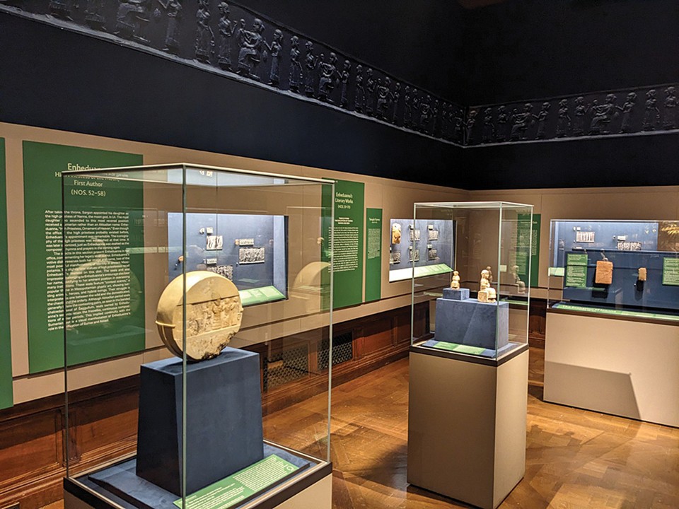 Installation view of the She Who Wrote: Enheduanna and Women of Mesopotamia, ca. 3400–2000 BC exhibition at the Morgan Library & Museum, showing a series of ancient Mesopotamian artifacts including the Disk of Enheduanna.