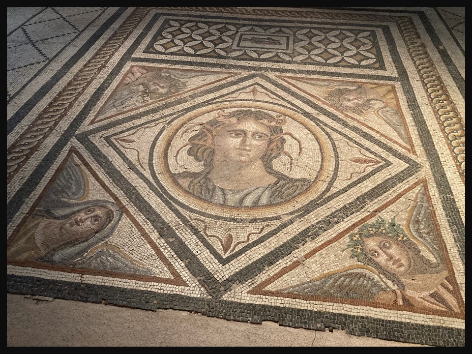 Floor mosaic from the House of Euripos (2nd–3rd century AD), showing a central youthful sea spirit surrounded by personifications of the Four Seasons, Archaeological Museum of Mytilene, Greece.