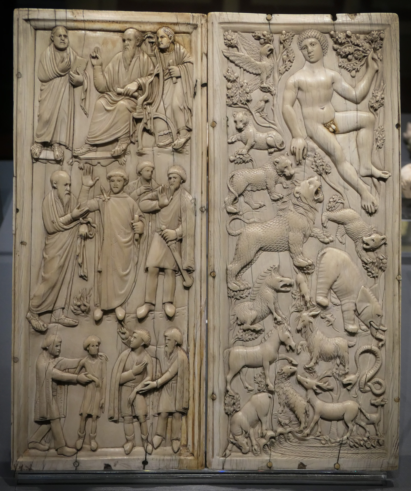 Early Christian Ivory Diptych with two carved scenes: episodes from the life of St. Paul and Adam standing in the Earthly Paradise. Small, stylized figures and minimal backgrounds are rendered in fine low relief on a warm, aged ivory surface.