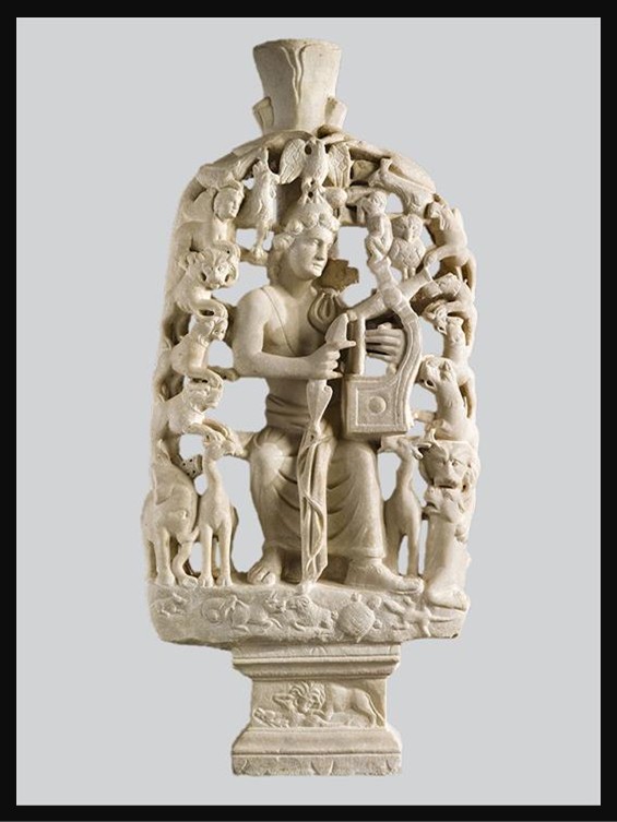 Marble table support (trapezophoron) from the 4th century AD depicting Orpheus seated and playing a lyre beneath a tree, surrounded by a dense assemblage of real and mythical animals and birds. The sculpture is housed in the Byzantine and Christian Museum in Athens, Greece.